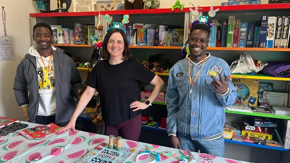 Three people volunteering in the Refuweegee shop